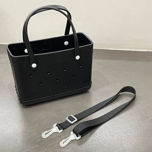 Detail of a medium black EVA beach tote bag featuring holes and a detachable shoulder strap