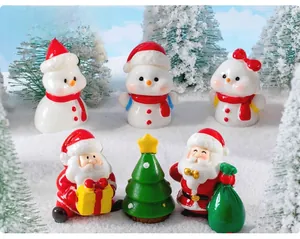 Close-up of miniature resin Christmas figurines including Santa and snowman set