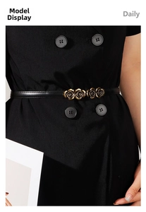 Detail of adjustable black belt with gold rose buckle on elegant dress for women