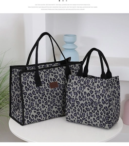 Detail view of two large capacity leopard print tote bags in grey canvas with woven handles
