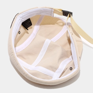 Breathable beige docker hat made of polyester with visible inner lining and labels