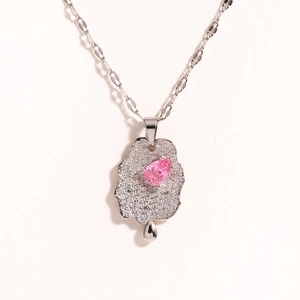 Detailed view of silver necklace with cloud pendant, pink teardrop stone and fine zircons
