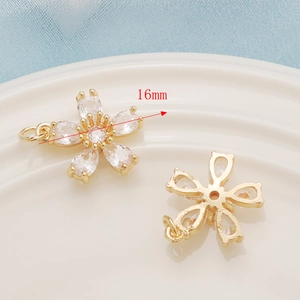 Macro view of 16mm 14K gold plated flower pendant with clear zircon stones for DIY jewelry
