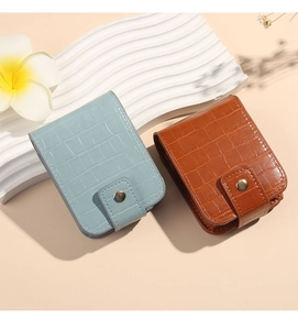 Close-up of crocodile pattern PU leather lipstick bags in blue and brown with metal snap