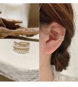 Detail of four-row gold ear cuff with pearls and rhinestones shown on model