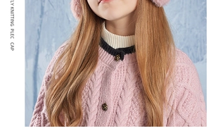 Detail of pink knitted cardigan with vintage buttons and faux fur earflap hat for winter