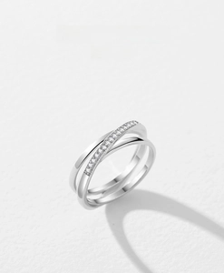 Detailed view of overlapping S925 silver rings with pavé cubic zirconia and polished bands