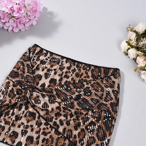 Close-up of leopard print skirt featuring shimmering sequins and textured fabric detail