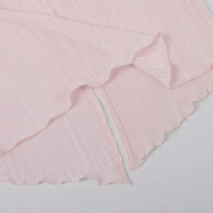 Macro detail of pleated pink fabric texture with ruffled hem and delicate wavy edges