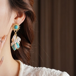 Vintage gold drop earrings featuring turquoise and pearl tassels in a bohemian luxury style