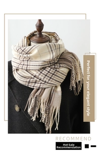 Close-up of beige plaid cashmere-like scarf with fringe detail on a dark wool coat
