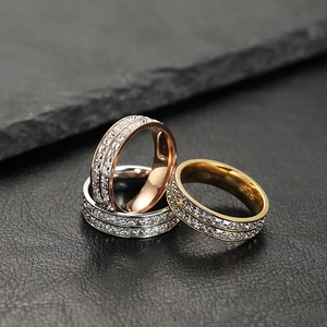 Detailed shot of double-row cubic zirconia rings in rose gold, silver, and gold finishes