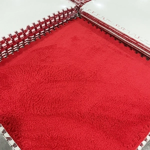 Detailed close-up of red plush interlocking foam floor mat with jagged edge connectors