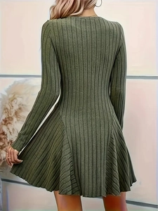 Detailed back view of an olive green knit dress with fine vertical texture and flared hem