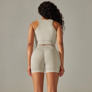 Detail view of seamless light green yoga set back with racerback top and high waist shorts