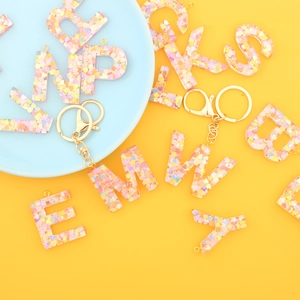 Colorful resin alphabet keychains with glitter heart sequins and gold metal hooks