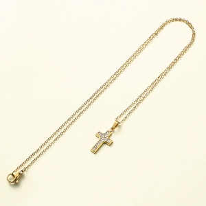 Elegant gold cross pendant necklace with clear zircon stones on a fine link chain
