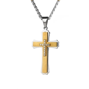Macro detail of layered silver and gold cross pendant with cubic zirconia stones