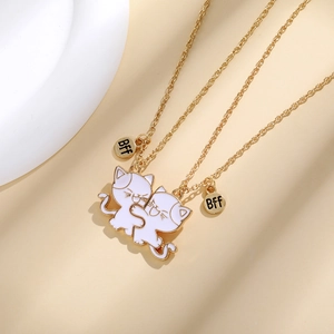 Golden Best Friends Forever necklaces with interlocking white enamel cat pendants