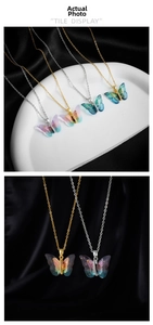 Detail of colorful resin butterfly pendant with cubic zirconia and gold chain