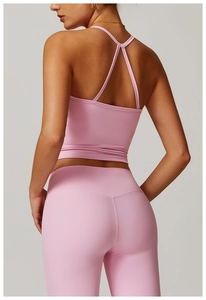 Detail view of pink yoga set showing the cross-back sports vest and high waist leggings