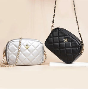 Close-up of quilted mini crossbody bags with metallic chain straps in black and silver