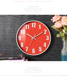 Close-up of a 12-inch silent wall clock with a red dial and white Arabic numerals