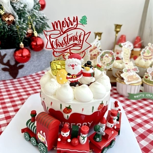 Close-up of Merry Christmas acrylic topper on red cupcake with festive holiday decor