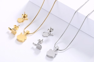 Detailed overhead view of guitar-shaped necklace and stud earring sets in gold and silver