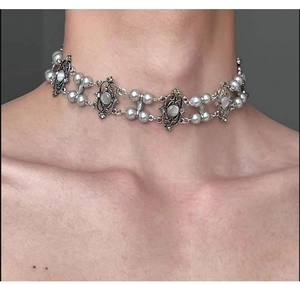 Close-up of a silver Y2K choker with baroque pearls and moonstones on a model neck
