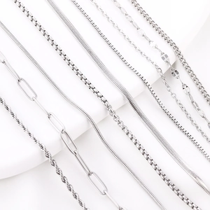 Detail view of various silver stainless steel chain styles including rope and snake links