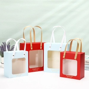Window gift bags in red and light blue with gold handles and transparent PVC display