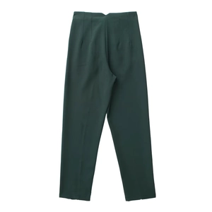 Detailed flat lay of dark green high-waisted trousers with smooth fabric texture