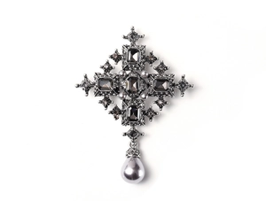 Detail of baroque cross brooch with grey gemstones and hanging teardrop pearl pendant