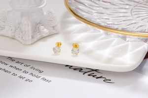 Detailed shot of gold-plated S925 silver stud earrings with four-prong round zircon