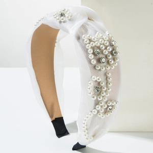 Detail of white mesh headband featuring elegant pearl clusters and crystal rhinestones