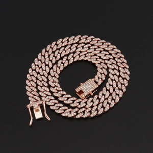 Detail of 8mm rose gold Cuban chain with crystal stones on a sleek black background