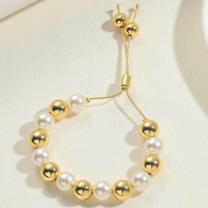 Detail of 14K gold plated beaded bracelet with pearls and adjustable sliding clasp