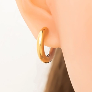 Polished 18k gold plated stainless steel chunky hoop earrings worn by model