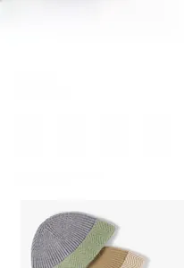 Detail of thick knit herringbone pattern on a two-tone winter warm bucket hat