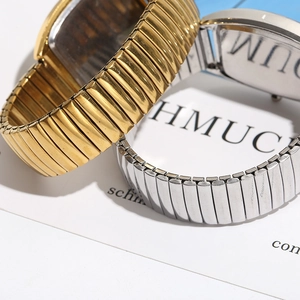 Detailed view of vintage gold and silver stretch metal watch bands with spring links