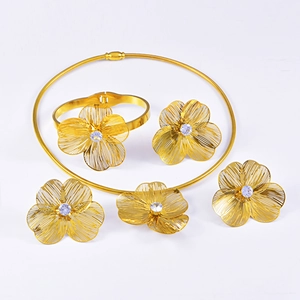 Detailed view of brushed gold flower jewelry set with sparkling zircon centerpieces