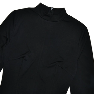 Detail view of high neckline with back zipper closure on this black slim fit dress