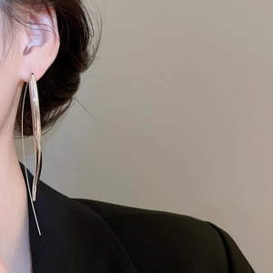 Silver teardrop long hook earring shown on model with polished metal finish