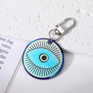 Macro shot of large round Evil Eye pendant with bohemian tribal geometric patterns