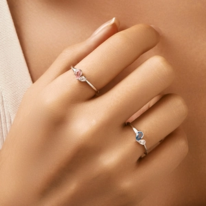 Elegant S925 silver rings with teardrop-shaped pink and blue gemstones on a hand