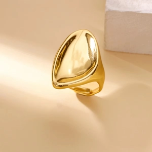 Macro detail of high-polished golden ring with an abstract organic flower shape design