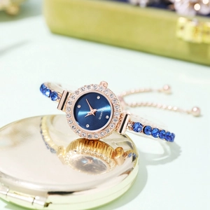 Elegant rose gold women's watch with blue dial and sparkling rhinestone bracelet