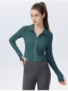 Close-up of waffle-textured dark green yoga jacket with zipper and thumbhole details