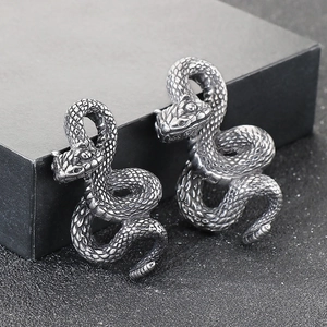 Detailed close-up of punk style snake pendants with antique black finish and scale textures